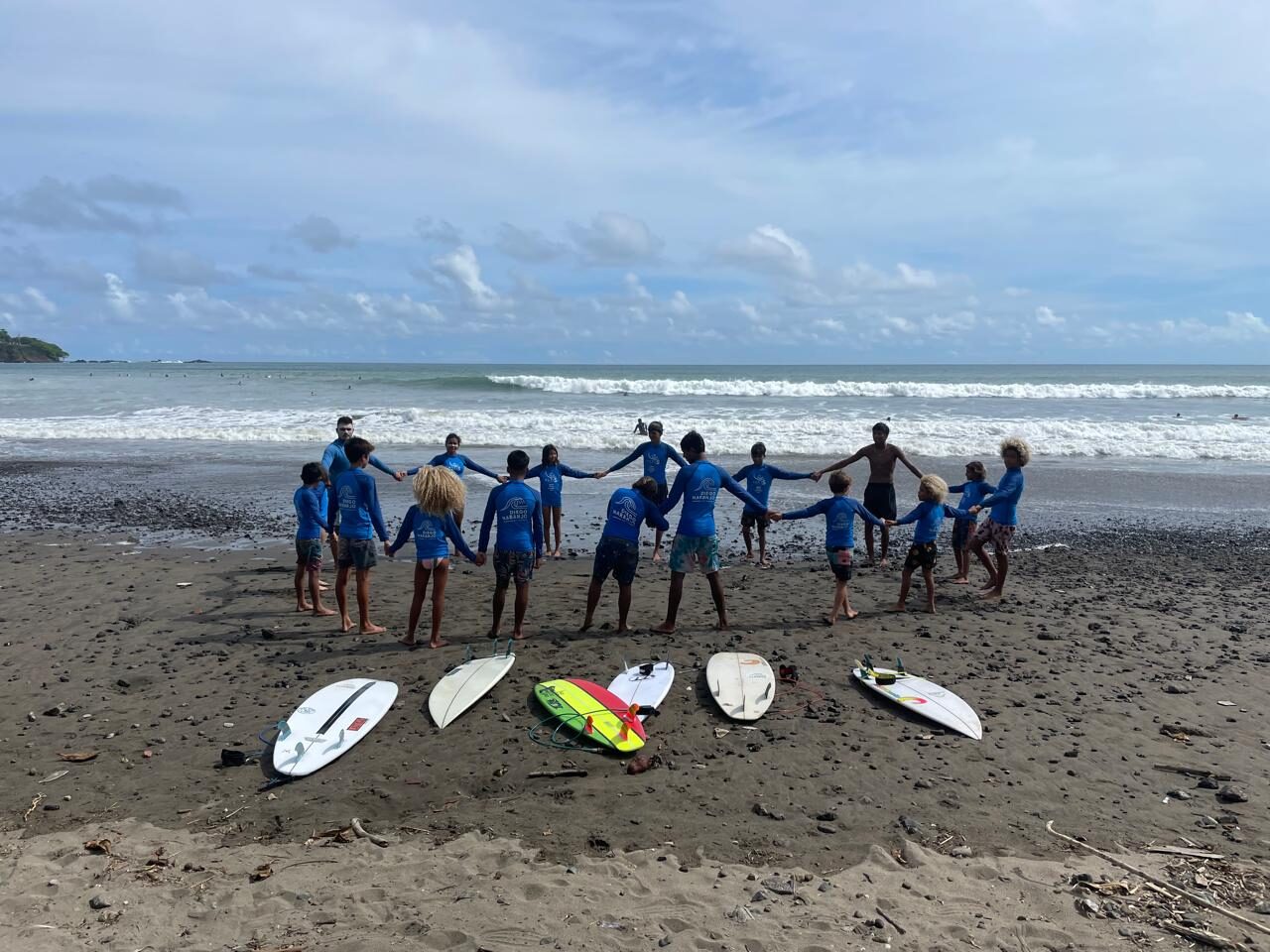 Estudiantes con tablas en la playa